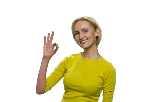 Portrait of young woman in yellow showing okay gesture isolated on the white background. — Stock Photo, Image