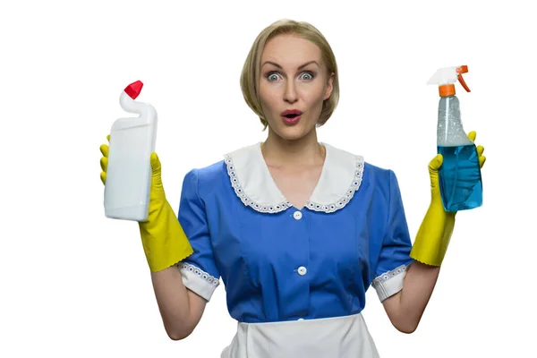 Surprised maid holding cleaner spray and toilet disinfectant on white background. — Stock Photo, Image