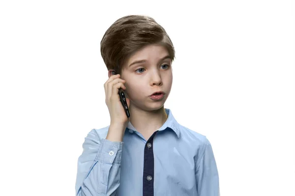 European white boy in blue shirt talking on smartphone on white background. — Stock Photo, Image