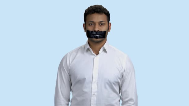 Portrait of young Indian man with taped mouth. — Stock Video