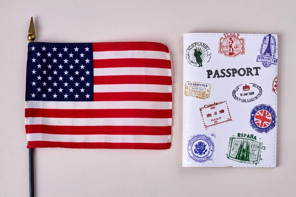 Flag of the United states and travel passport with stamps.