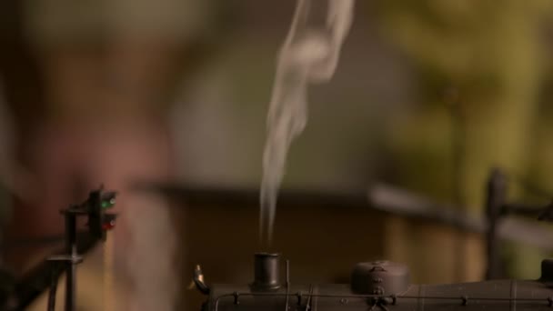 Close up smoking chimney of toy steam locomotive. — Stock Video