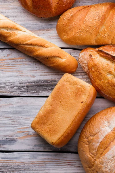 Плоский покласти різні хлібні хліби на дерев'яному фоні . — стокове фото