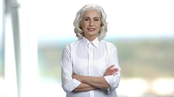 Portret van senior zakenvrouw op wazige achtergrond. — Stockvideo