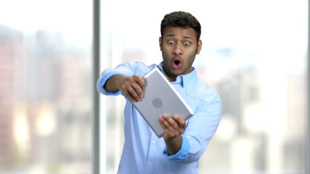 Expressive businessman playing game on digital tablet. — Stock Video