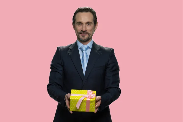 Portrait of businessman giving gift box.