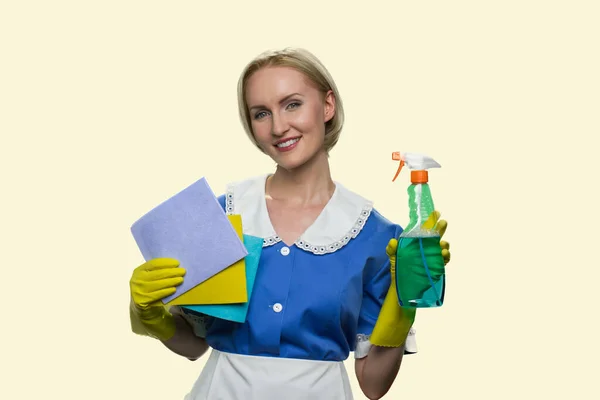Housekeeper in uniform holding cleaning supplies. — Stock Photo, Image