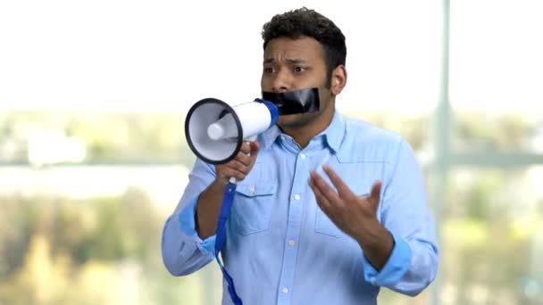 Displeased guy with taped mouth can not speak. — Stock Video