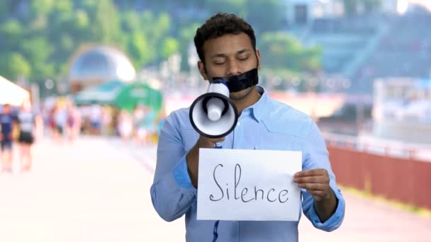 Silenced man holding megaphone. — Stock Video