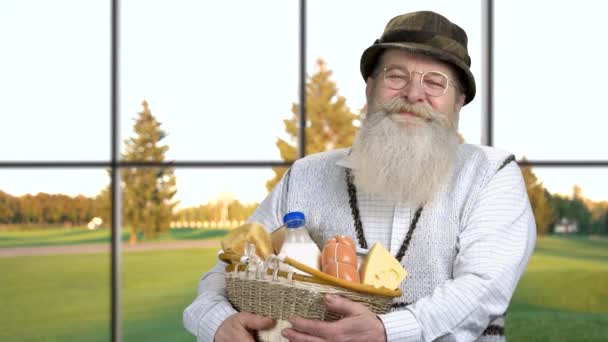 Campesino sonriente sosteniendo canasta con comida saludable. — Vídeos de Stock