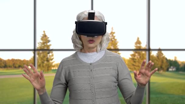 Зрелая женщина в очках виртуальной реальности. — стоковое видео