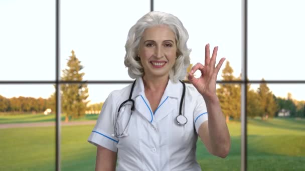 Χαμογελαστή γυναίκα γιατρός δείχνει OK σημάδι. — Αρχείο Βίντεο
