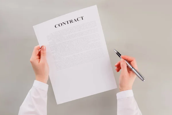 Manos femeninas con contrato de negocios y pluma. — Foto de Stock