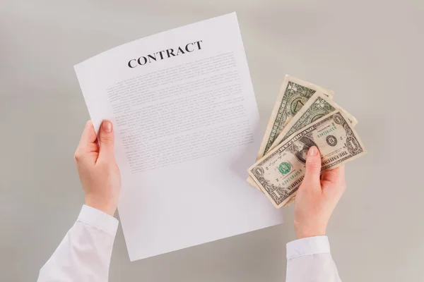 Document and money in womans hand. — Stock Photo, Image