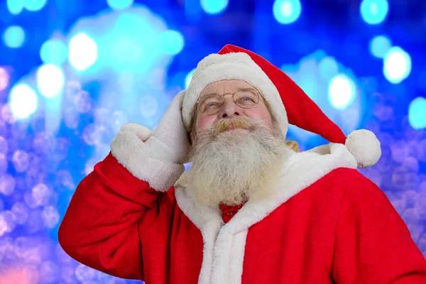 Santa Claus på blå skimrande bakgrund. — Stockfoto