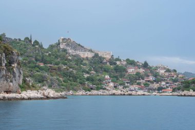 Türkiye 'nin yeni Demre kenti olan dağların yamaçlarındaki antik Kekova kalesi ve köyü