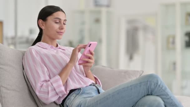 Excited Latin Woman Celebrating Success on Smartphone at Home — Stock Video