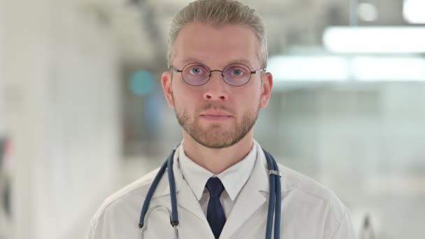 Portrait of Serious Young Male Doctor Looking at the Camera — Stok Video