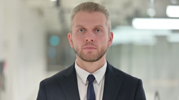 Portrait of Serious Young Businessman Putting Finger on Lips — Stock Video