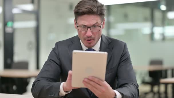 Retrato del hombre de negocios de mediana edad que tiene pérdida en la tableta — Vídeos de Stock