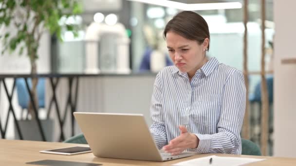 Расстроенная молодая женщина, потерявшая ноутбук в офисе, неудача — стоковое видео