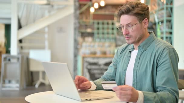 Сбой в оплате онлайн на ноутбуке от человека среднего возраста в кафе — стоковое видео