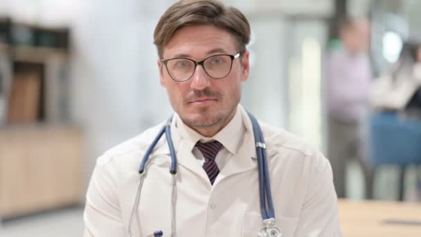 Portret van een positieve mannelijke arts met duimen omhoog Aanmelden — Stockvideo