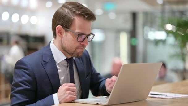 Empresário reagindo à perda no laptop no trabalho — Vídeo de Stock