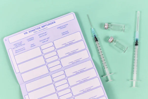 Concept for vaccination of pets with empty European vaccination dog passport with syringes and vials