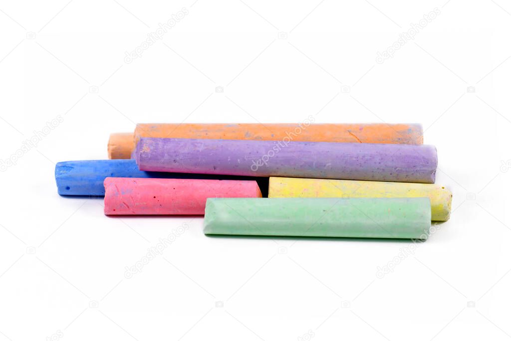 Various pastel colored chalk sticks isolated on white background