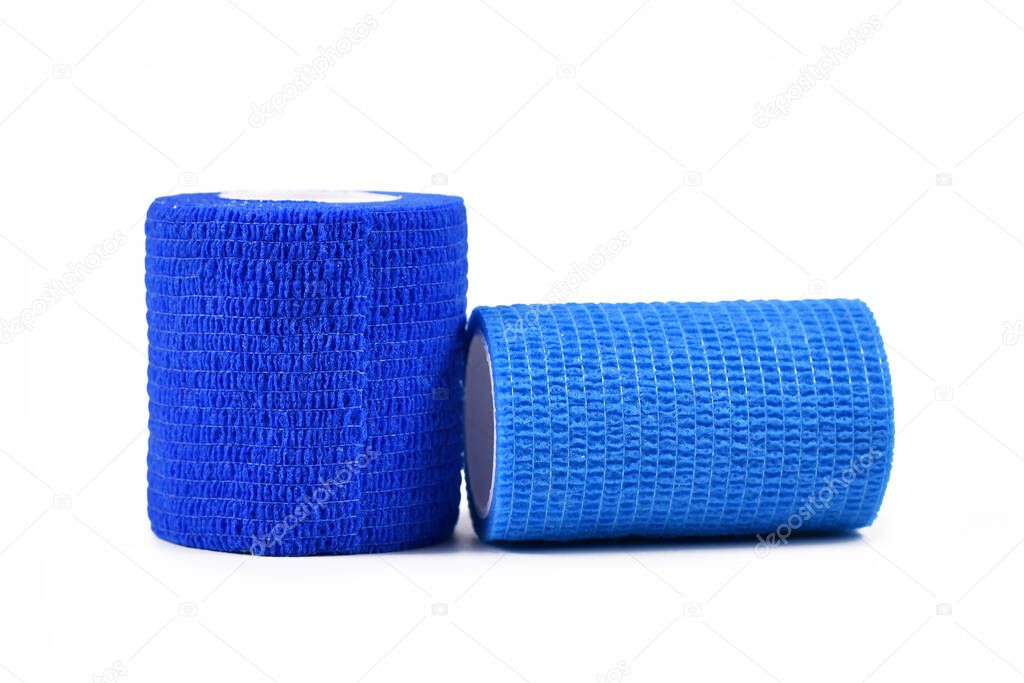 Two rolls of blue self adhesive medical elastic bandages isolated on white background