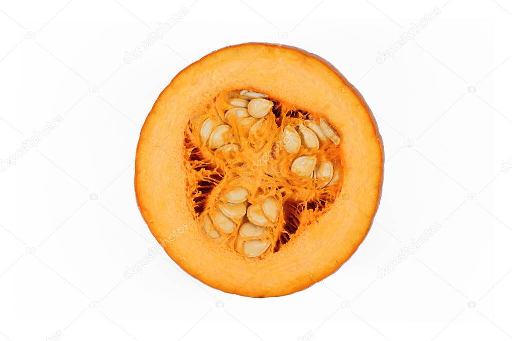 Cut open 'Baby Bear' Halloween pumpkin showing vegetable meat and seeds inside. Isolated on white background
