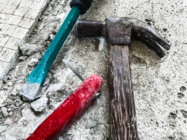 hammer and chisel lie on the floor