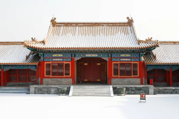 Snow covered red chinese building in Beijing