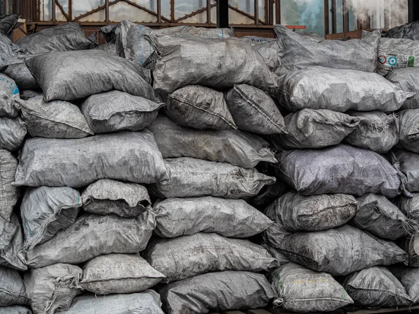 pile of bags of soil and coal, agriculture, Soil bag stack in warehouse. Organic Fertilizer Bag in the market. (selective focus). Background bags