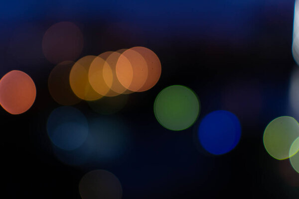 Round colored bright multicolored lights, orange red green blue yellow circles, night city