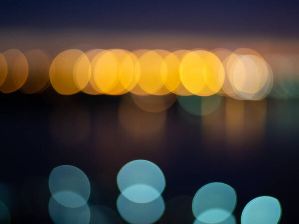 Color Bokeh against a dark back for use at graphic design, yellow and blue circle