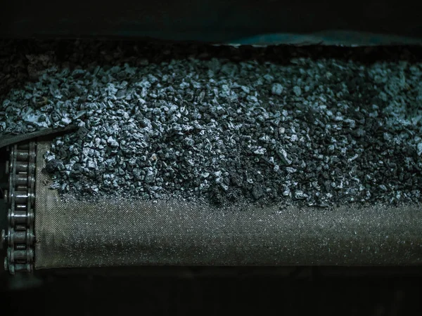 View inside a coal factory, charcoal on the conveyor. Used for carburizing gear. Carbiruser