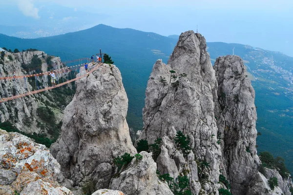 Ukrayna, Kırım 'daki Ai-Petri' de kayalık uçurum manzaralı ip köprü. En yüksek dağ ve turistik eğlence. Uçurumun üzerindeki Ai-Petri 'de asılı köprü.
