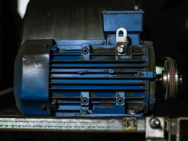 Industrial equipment blue hydraulic pump motor, blurred background. Coal industry