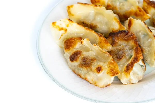 Hamur köfteleri kızartma yağıyla kaplı bir tavada kızartılmış ve bir tabakta servis edilmişti..