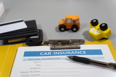 toy car, pen, document, car insurance concept on table clipart
