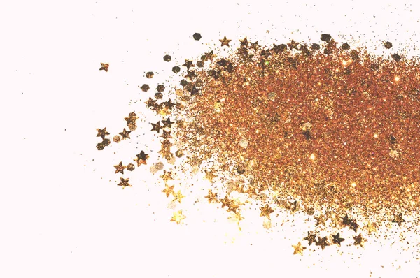 Golden glitter and glittering stars on white background