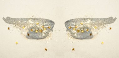 Golden glitter and glittering stars on abstract black watercolor wings in vintage nostalgic colors. clipart