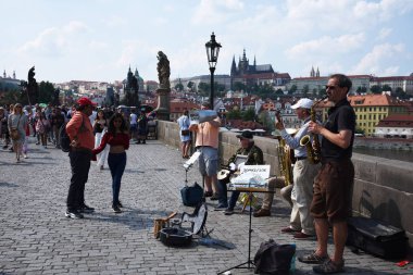 Prague, Czech Republic, May 12, 2018 - Tourists walk along the Charles Bridge on a sunny spring day.