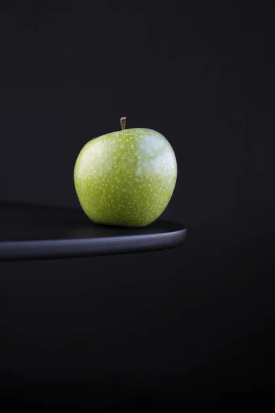 Green apple isolated on black background with copy space
