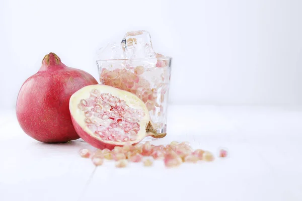 Pomegranates Glass Water Ice White Background Copy Space — Stock Photo, Image