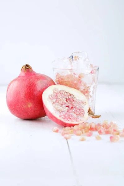 Pomegranates Glass Water Ice White Background Copy Space — Stock Photo, Image