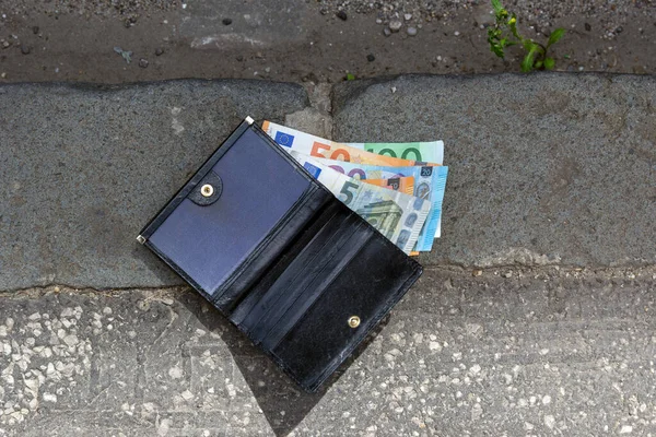 Lost Wallet with money between , tossed, banknotes, euros.