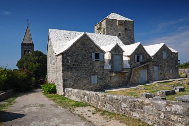 Historic stone houses in Island Brac, church, Supetar, Croatia. clipart
